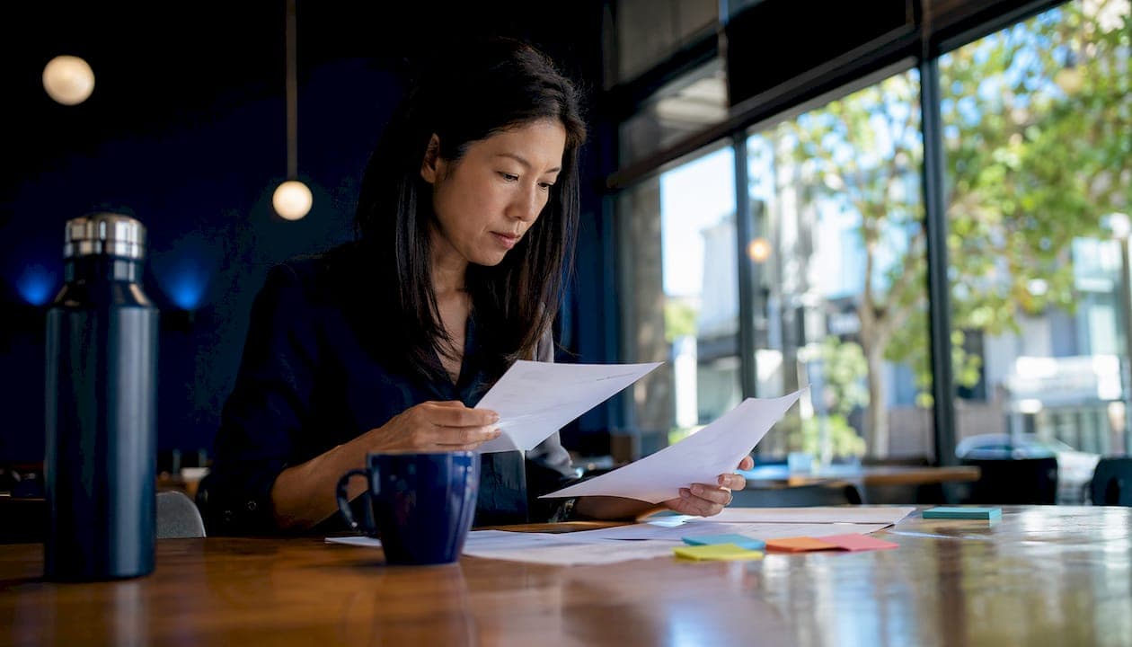Professional sorting emails at a home office desk